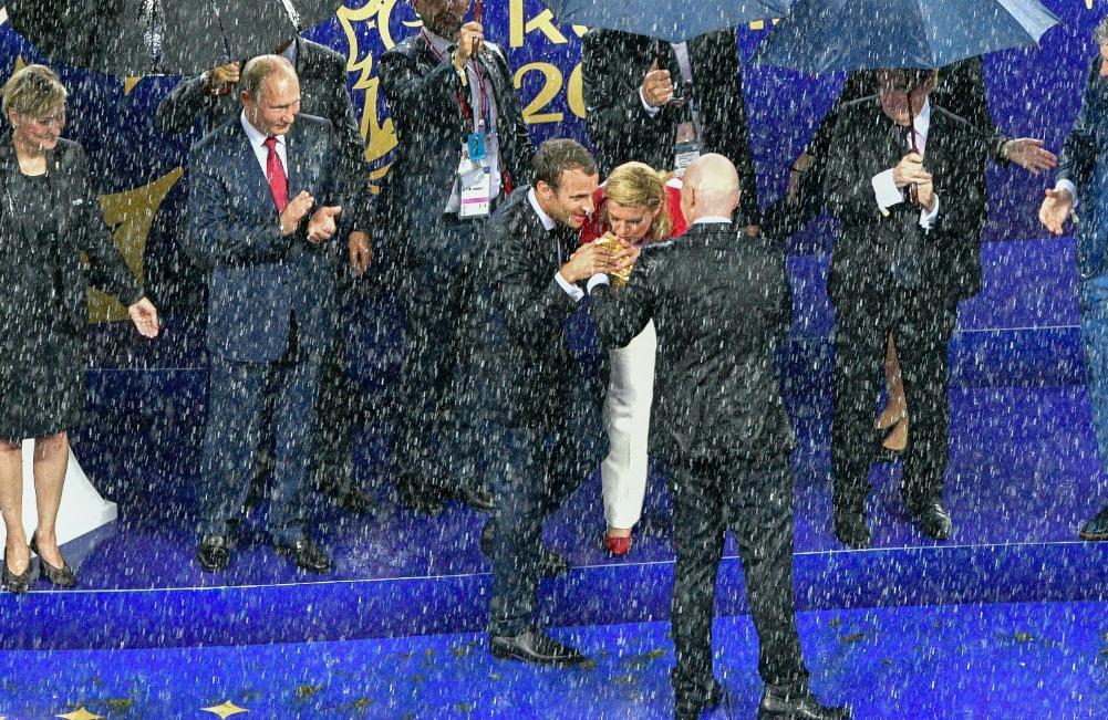 Nevjerovatne fotografije nakon finala: Kolinda i Makron mokri do kože ljube pehar, Putin ih gleda ispod kišobrana
